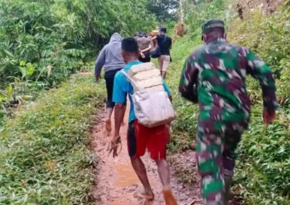 Kondisi Jalan Setapak, Licin dan Berlumpur, Satgas TMMD Bersama Warga Angkut Matrial dengan Berjalan Kaki